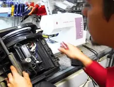 Vacuum repair technician servicing internal components on a workbench in Kansas City, KS