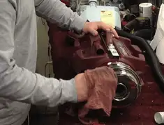 Vacuum repair technician cleaning and servicing a vacuum motor in Kansas City, KS